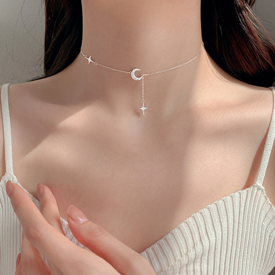 Silver necklace featuring star charm and celestial