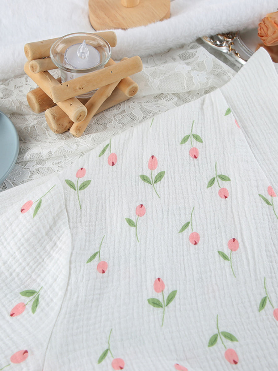 White cotton robe with pink floral print and green leaves, breathable fabric.