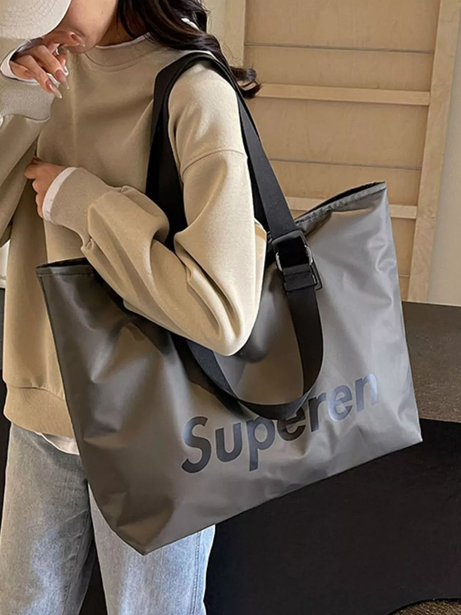 Spacious grey Oxford cloth travel shoulder bag with black strap and large "Supereren" graphic.