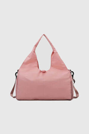 Dusty Pink duffel bag with dual handles and a crossbody strap, perfect for gym or travel.