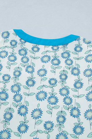 Floral dress in pastel blue with notched neckline and cap sleeves