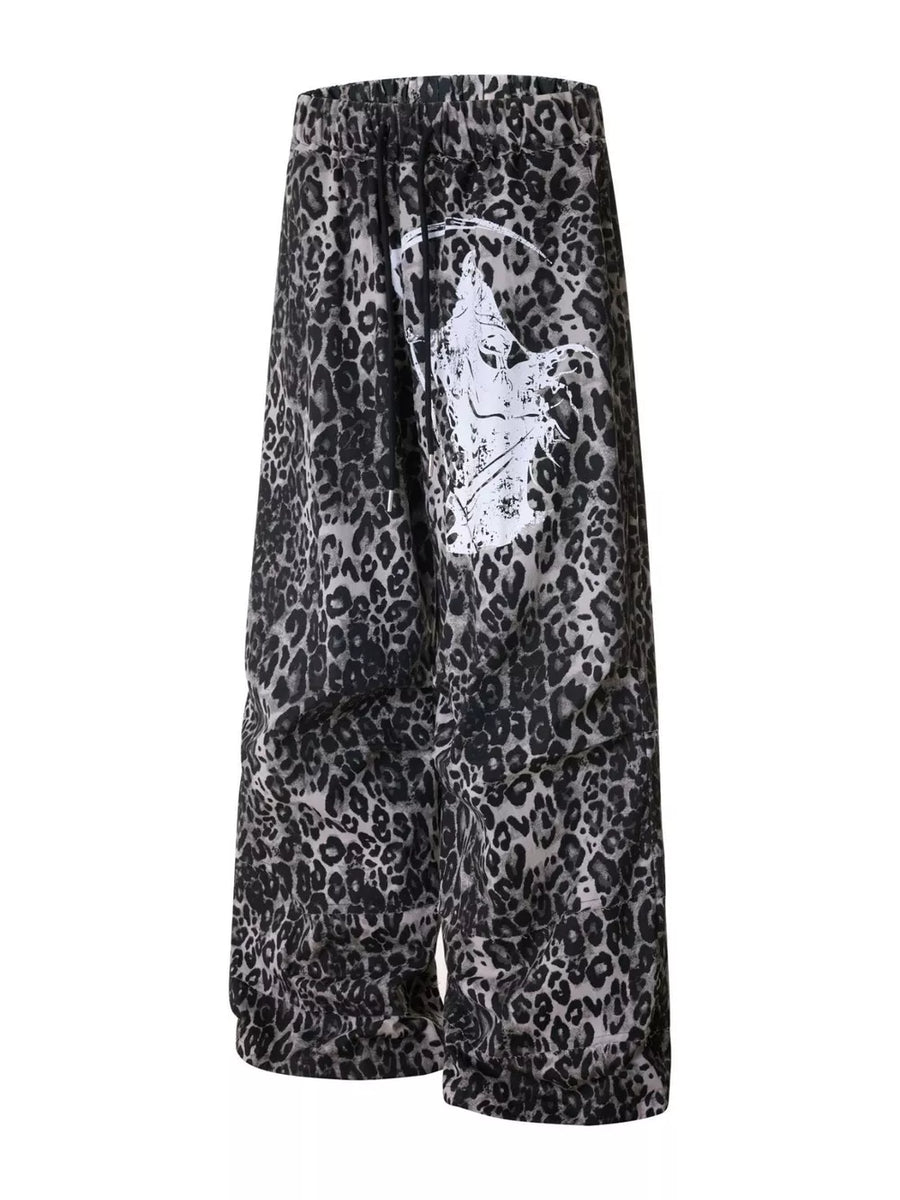 Leopard print cotton sweatpants with drawstring waist and wide leg, featuring a graphic print detail.