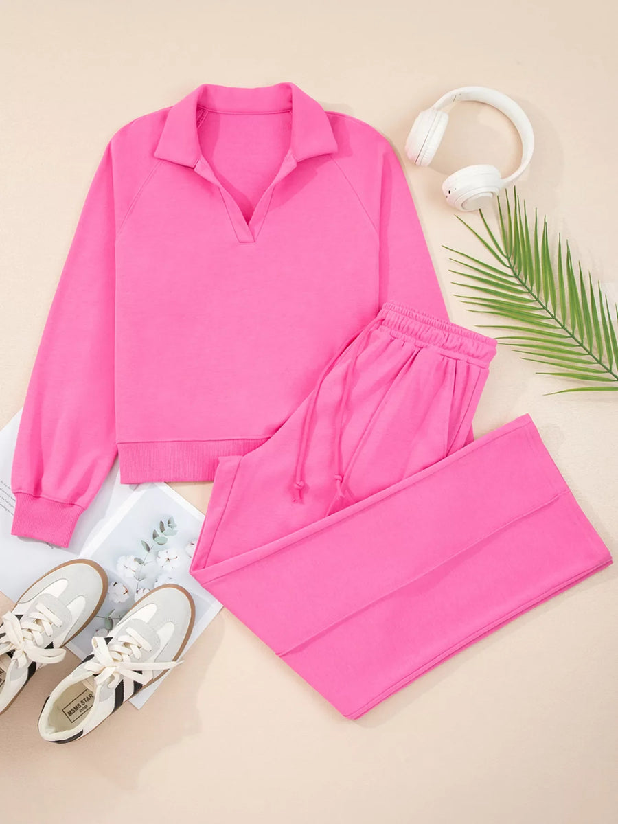 Hot pink collared pullover and drawstring pants set with a V-neck detail.