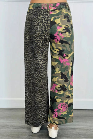 Contrast patchwork jeans with leopard print on one leg and floral camouflage on the other.