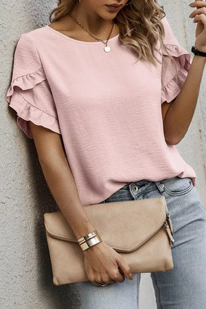 Blush pink polyester blouse with ruffle short sleeves and textured fabric.