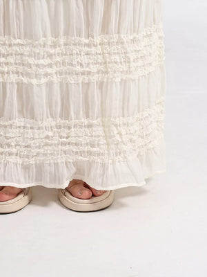 White tiered maxi skirt with smocked ruffles and a flowy hem