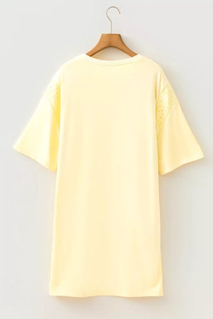 Yellow t-shirt with eyelet detail on sleeves and crew neck.