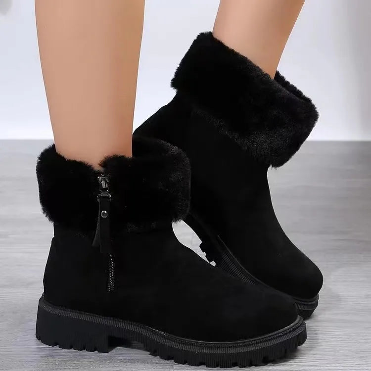 Black suede ankle boots with shearling trim and side zipper detail