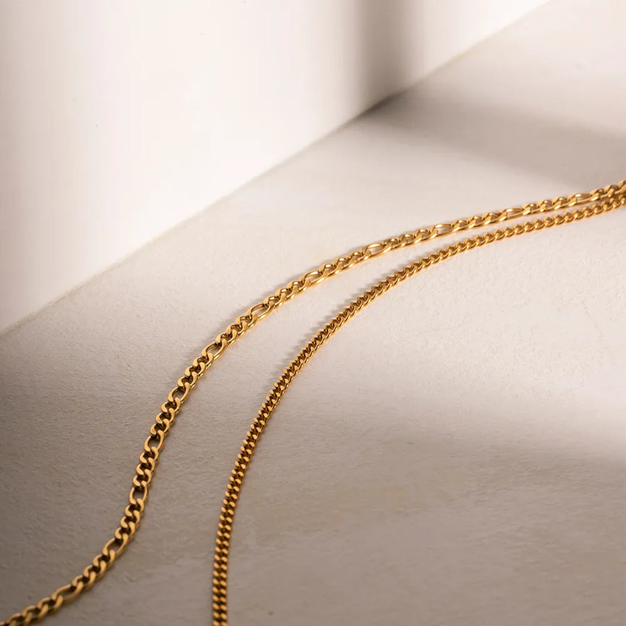 Gold dual-strand curb chain necklace with a figaro chain detail.