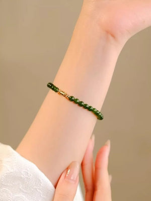 bracelet in dark green featuring beaded and fitted fit