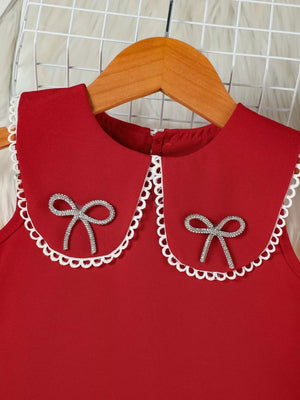 Red toddler dress with lace-trimmed collar and jeweled bows.