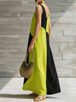Geometric v-neck maxi dress in lime and black colorblock, sleeveless, flowing skirt.