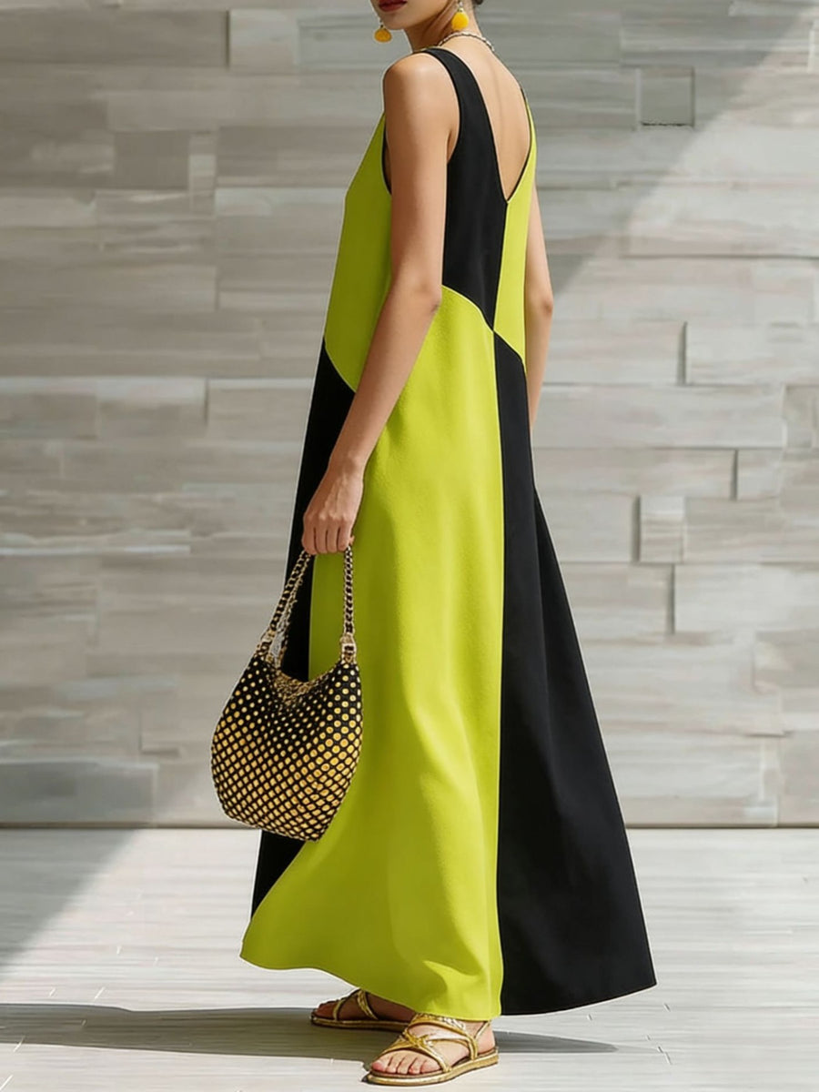 Geometric v-neck maxi dress in lime and black colorblock, sleeveless, flowing skirt.