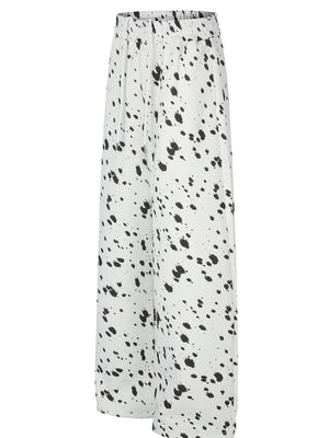 black wide-leg pants featuring elastic waist and paint splatter