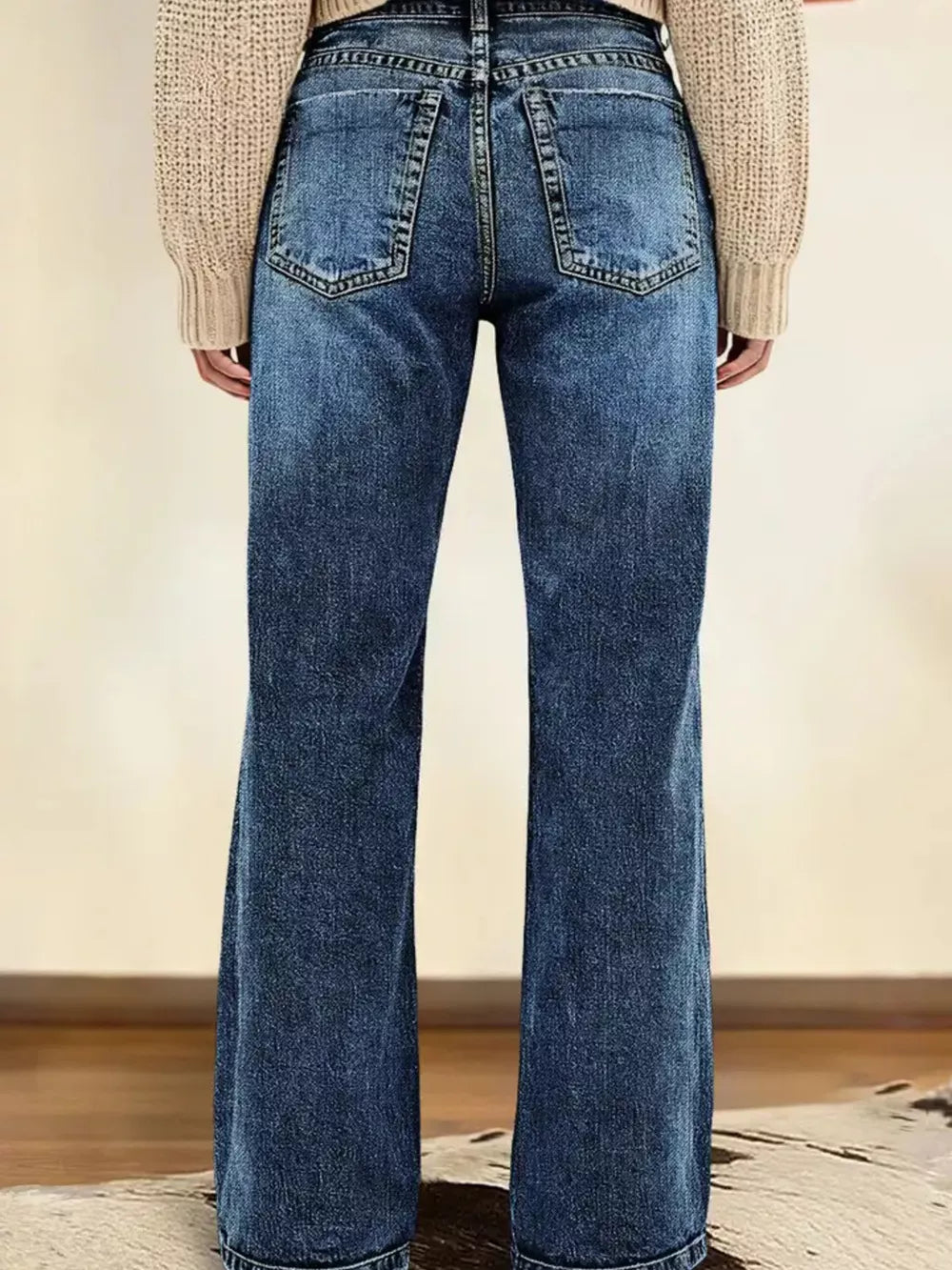 Dark blue denim straight leg jeans with vintage wash and buttoned closure.