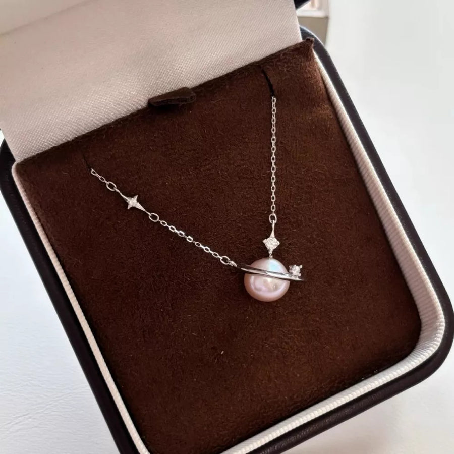 Celestial pearl and silver pendant necklace with diamond accents.