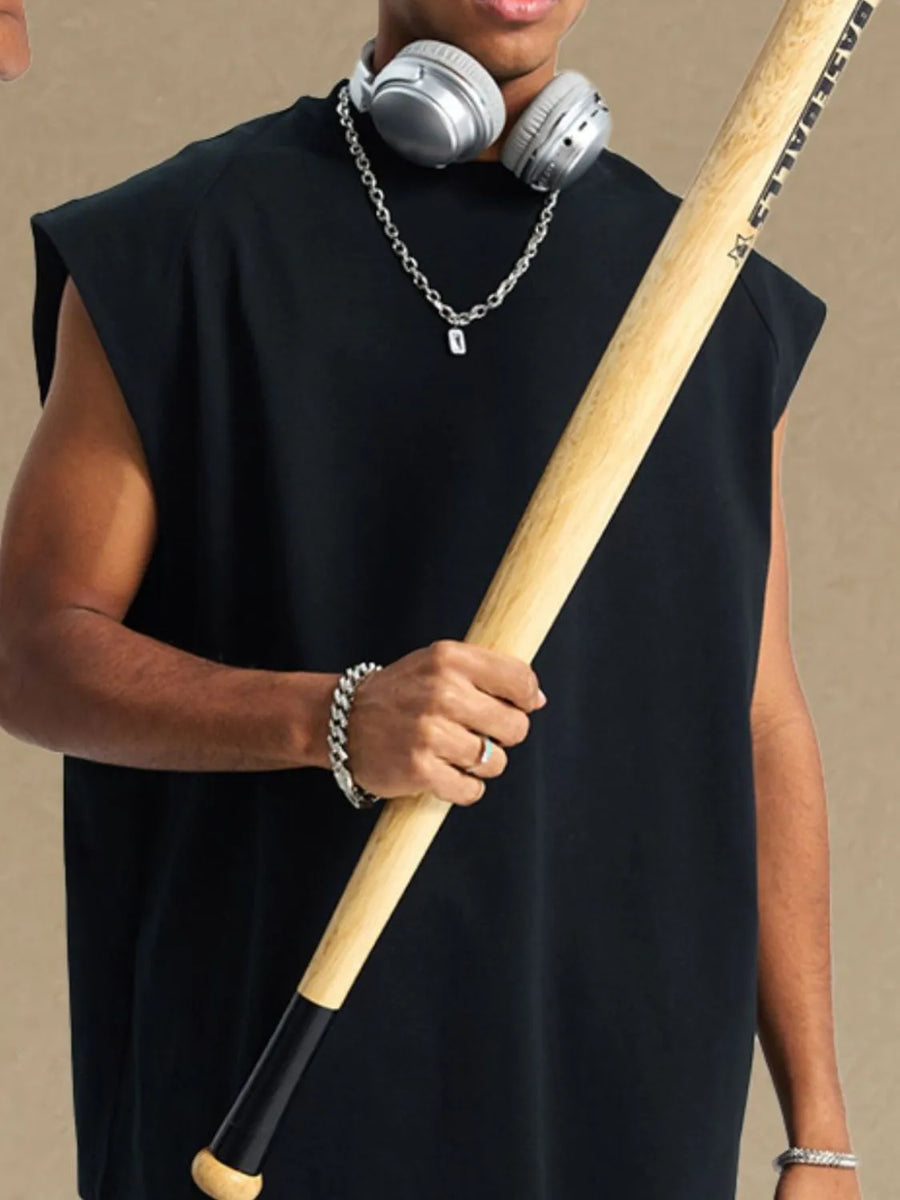 Black raglan shoulder sleeveless top with a relaxed fit, styled with jewelry and headphones.
