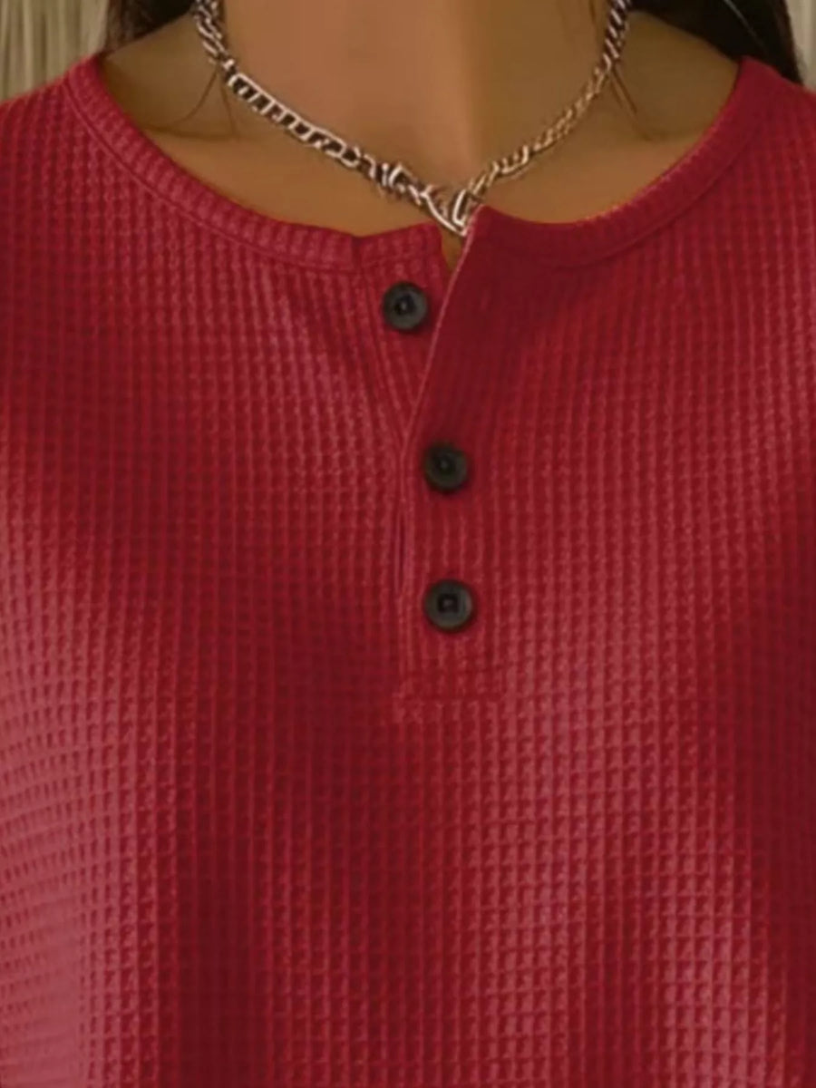 Red waffle knit henley top with button detail and crew neck.