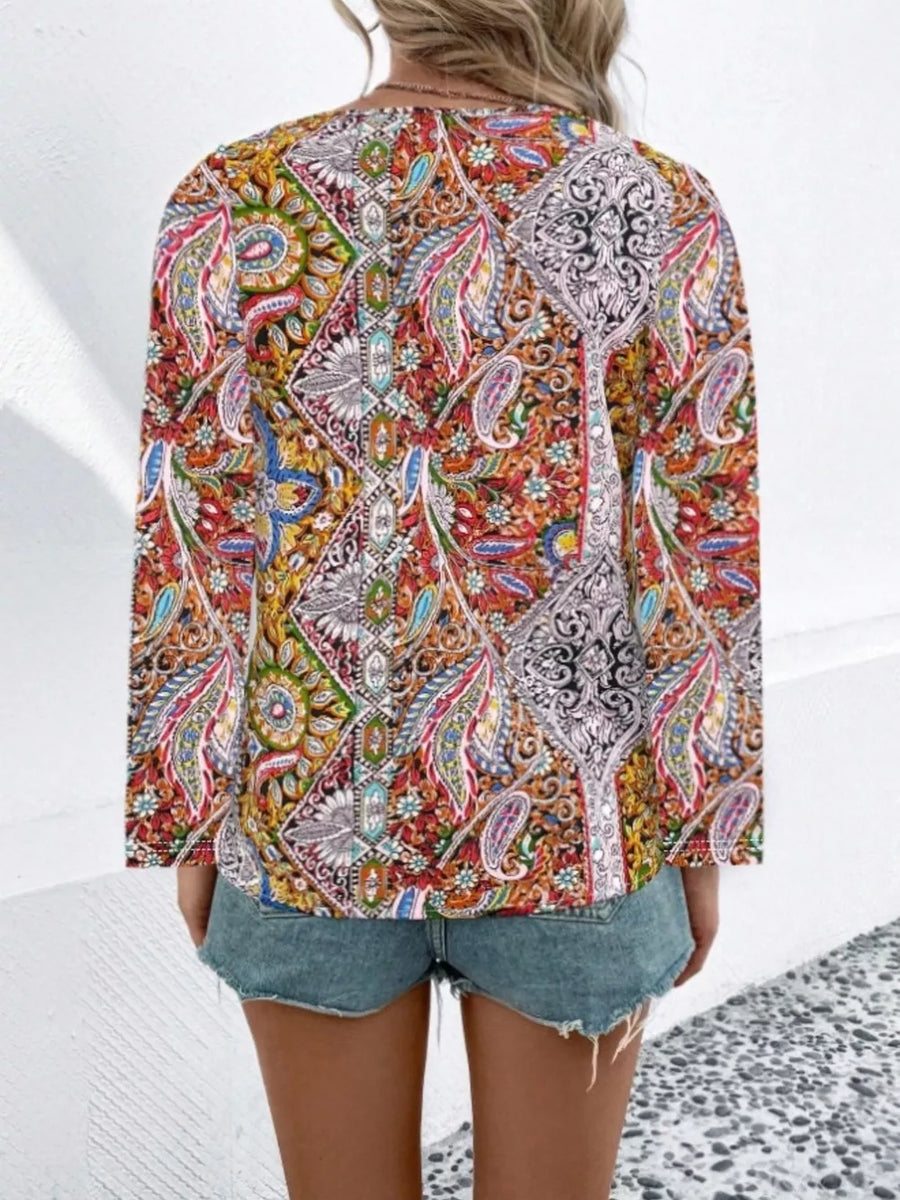 Bohemian paisley v-neck shirt in multicolor with long sleeves, styled with denim shorts.