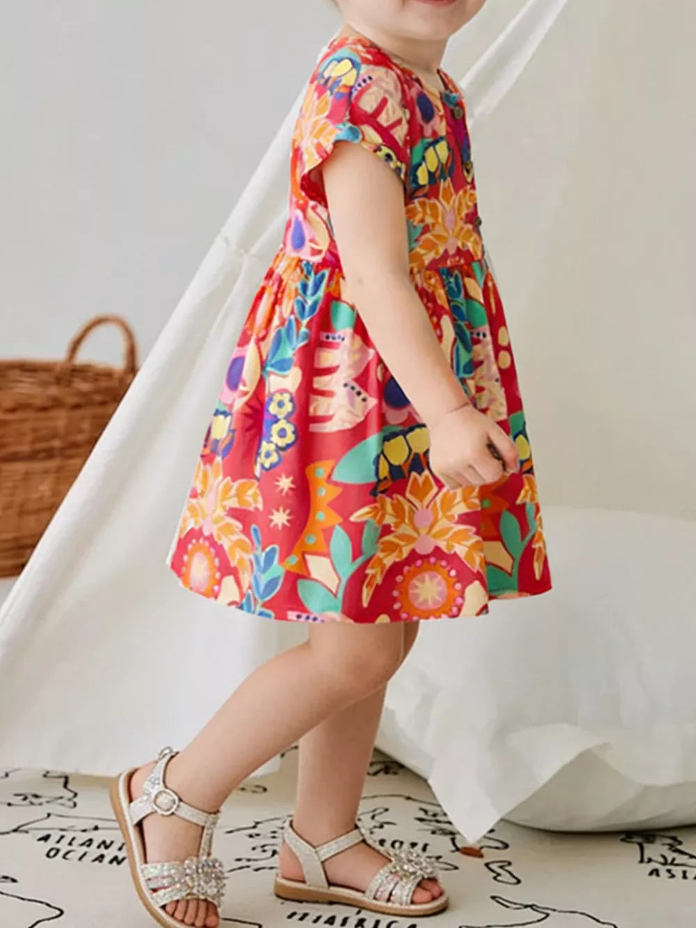 Toddler red cotton blend dress with vibrant floral print and button-down front.