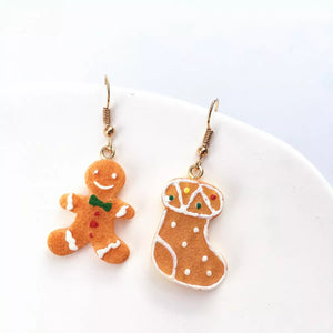 Gingerbread man and stocking Christmas earrings with festive icing details.