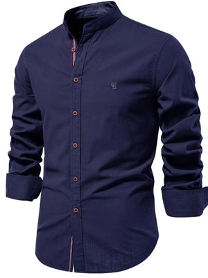 Navy linen shirt with mandarin collar, button front, and embroidered detail.