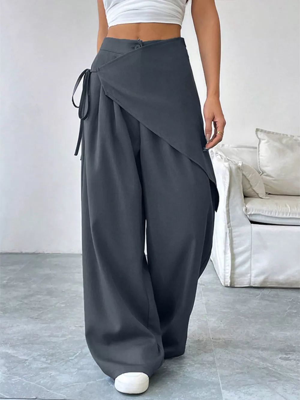 Dark gray wide-leg pants with wrap-style overlay and tie detail