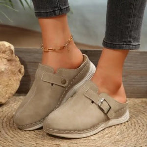 Buckle accent round-toe slip-on flats in khaki color with contrast stitching.