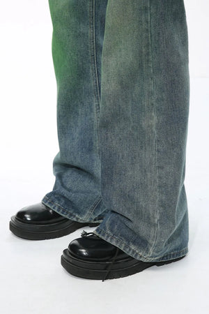 Ombre flare denim trousers in medium wash cotton, with a relaxed fit and slight green tint.