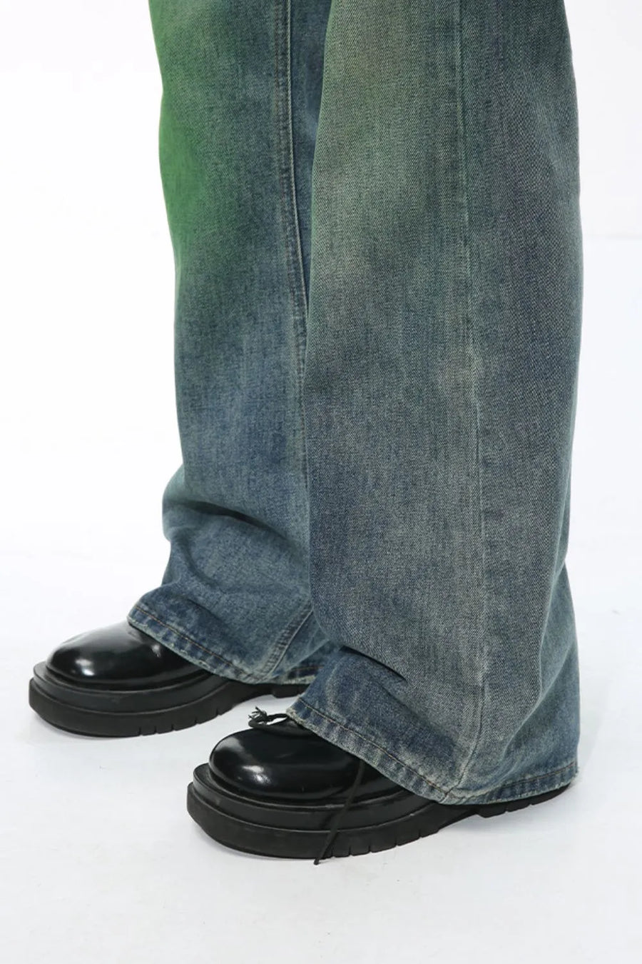 Ombre flare denim trousers in medium wash cotton, with a relaxed fit and slight green tint.