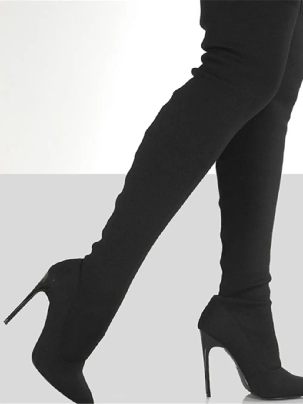 Black knit over-the-knee stiletto booties with a pointed toe.