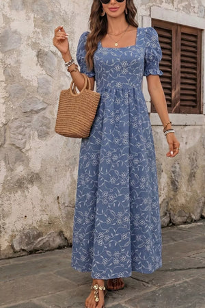Blue floral embroidered maxi dress with puff sleeves and square neckline.
