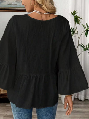 Black cotton V-neck blouse with bell sleeves and peplum hem
