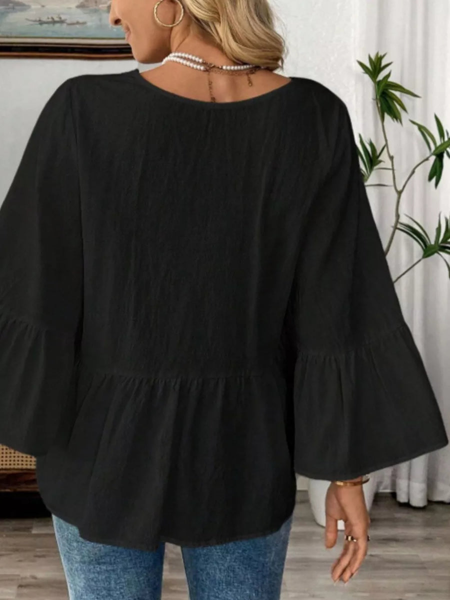 Black cotton V-neck blouse with bell sleeves and peplum hem
