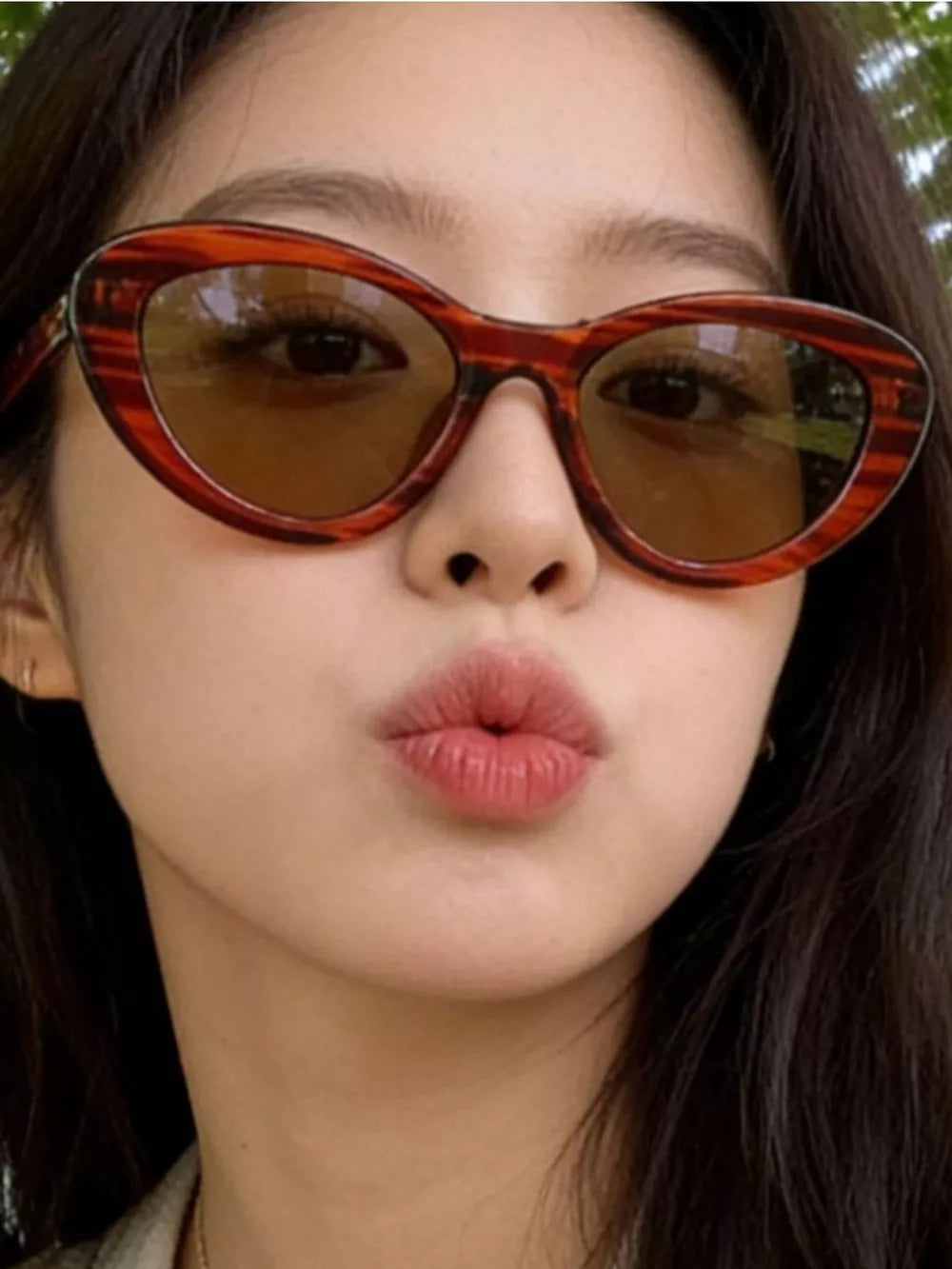 Cat eye sunglasses in tortoise shell pattern with brown lenses.