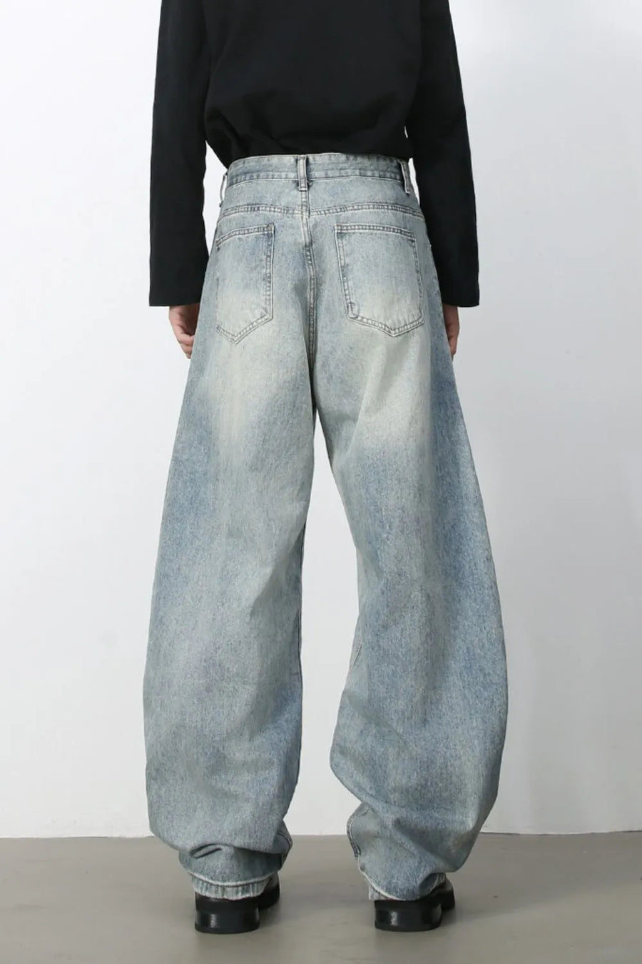 Faded light blue baggy denim jeans with a relaxed fit and distressed details.