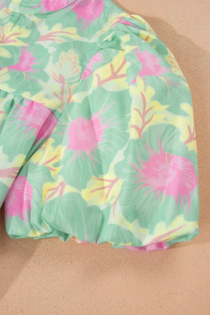 Pastel floral print polyester blouse with puff sleeves and ruffled hem detail.