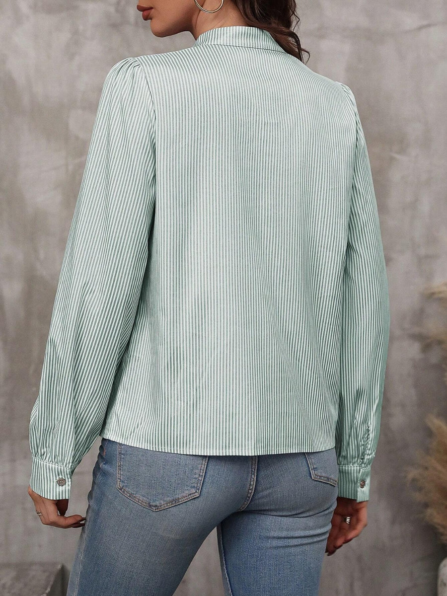 Green striped puff sleeve blouse with neck tie detail.