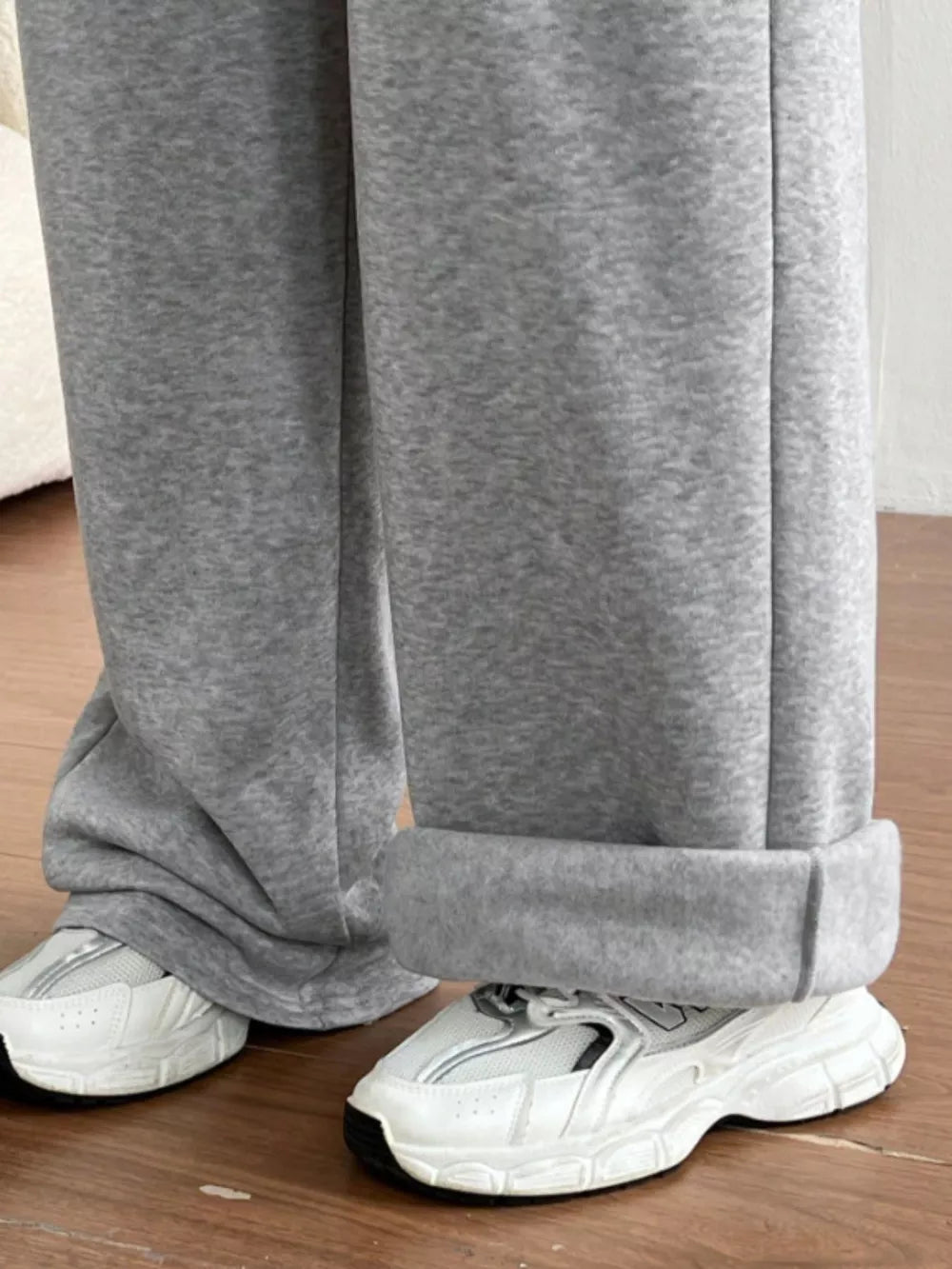 Gray wide-leg maternity joggers with cuffed hems shown with white sneakers.