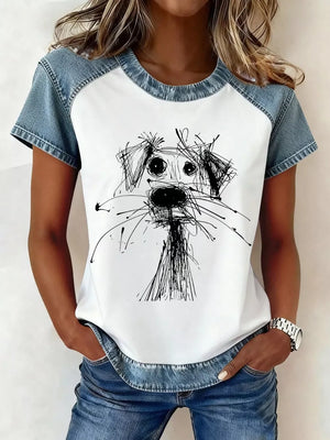 Denim patchwork short sleeve shirt with a graphic dog print on white.