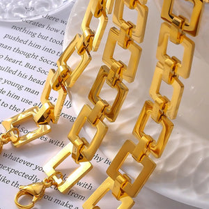 Gold geometric link bracelet with a bold, modern design.