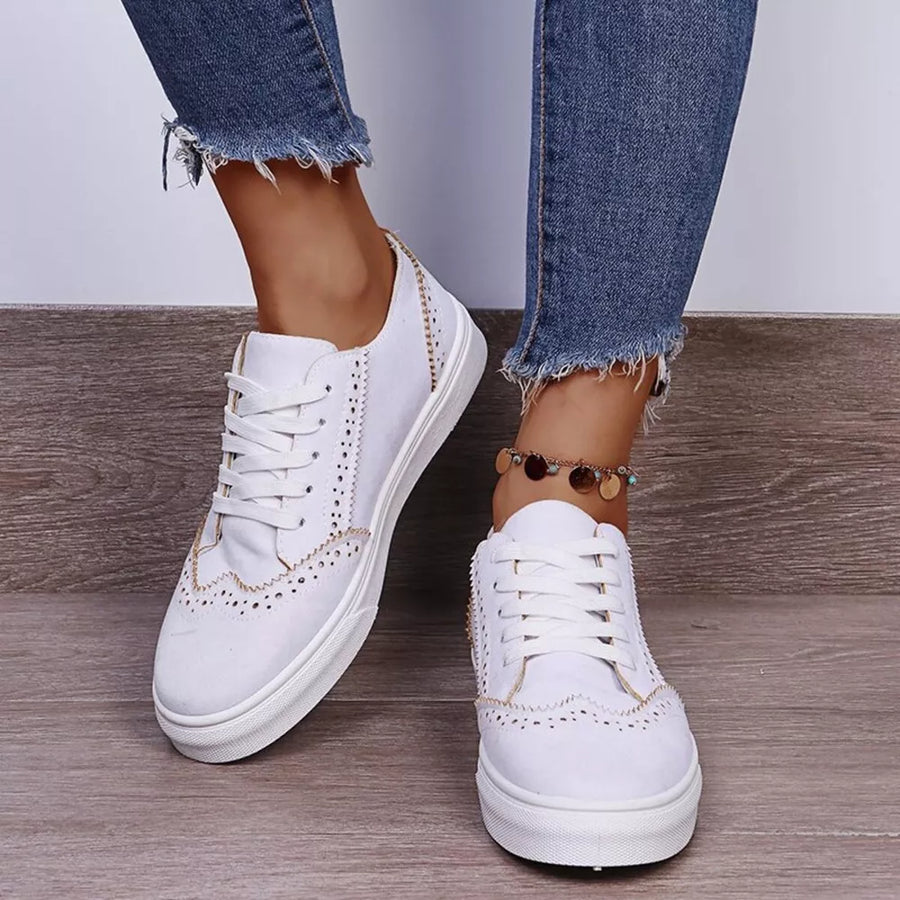 White matte finish lace-up sneakers with brogue detailing and decorative stitching.