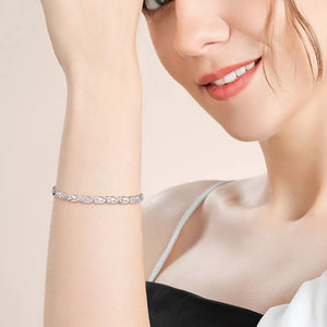 Interconnected heart link bracelet in sterling silver on a woman's wrist.