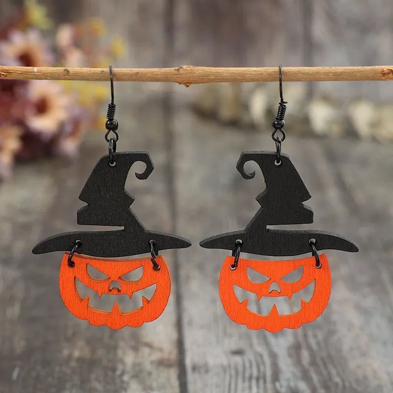 Black witch hat pumpkin Halloween earrings with carved faces.