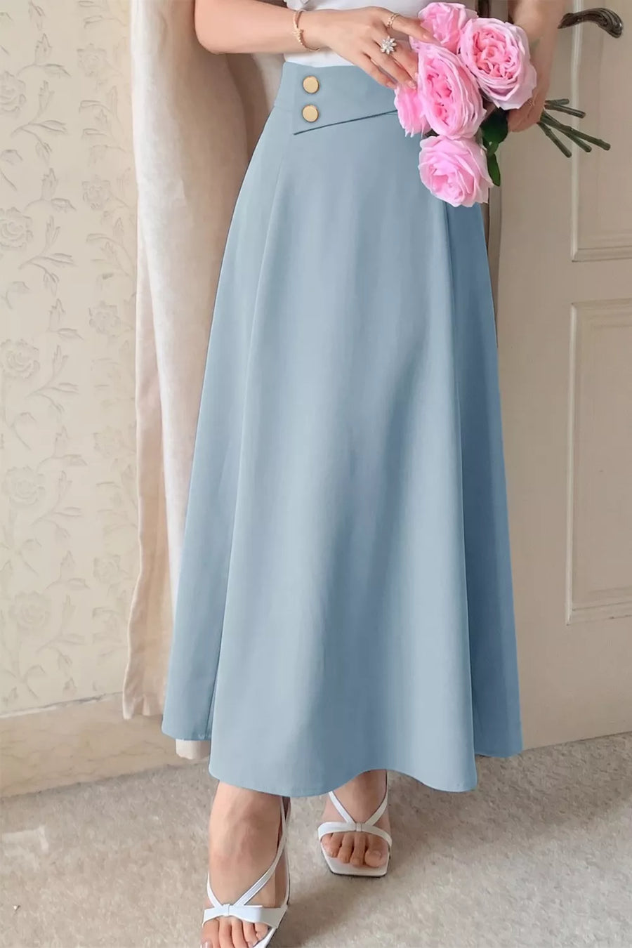 Light blue a-line midi skirt with gold buttons and asymmetrical detail