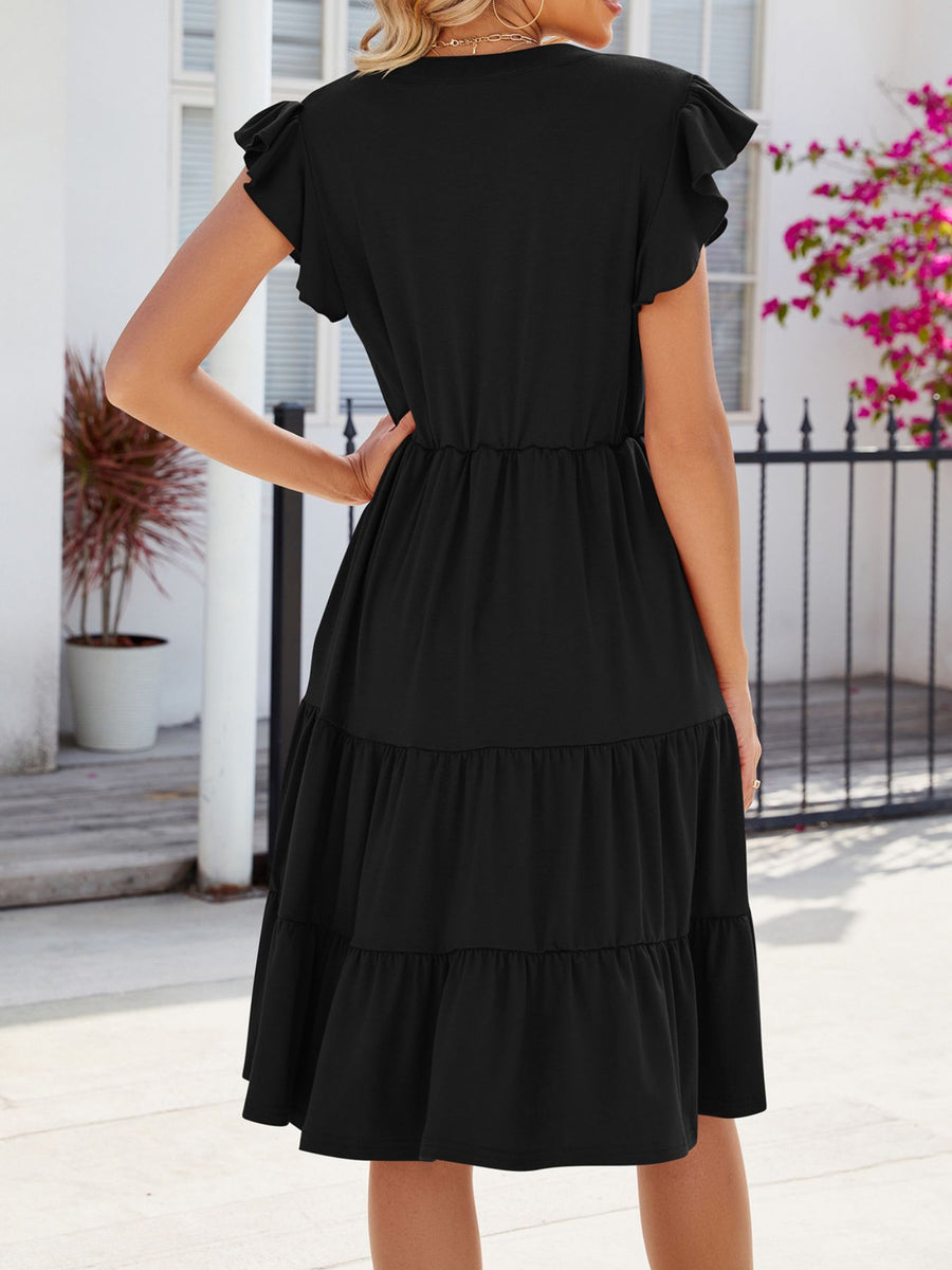 Black ruffled midi dress with tiered skirt and flutter sleeves.