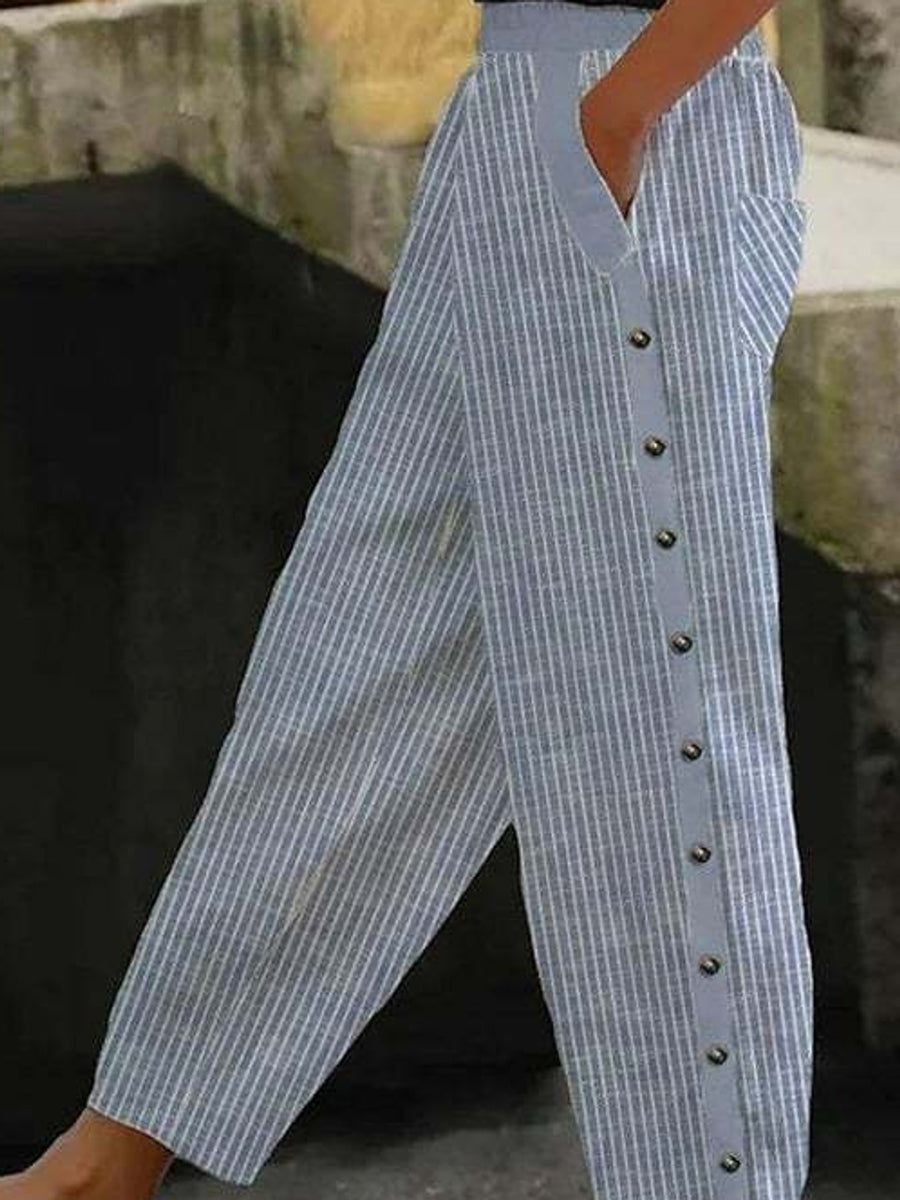 wide-leg pants in light blue featuring decorative button and relaxed fit