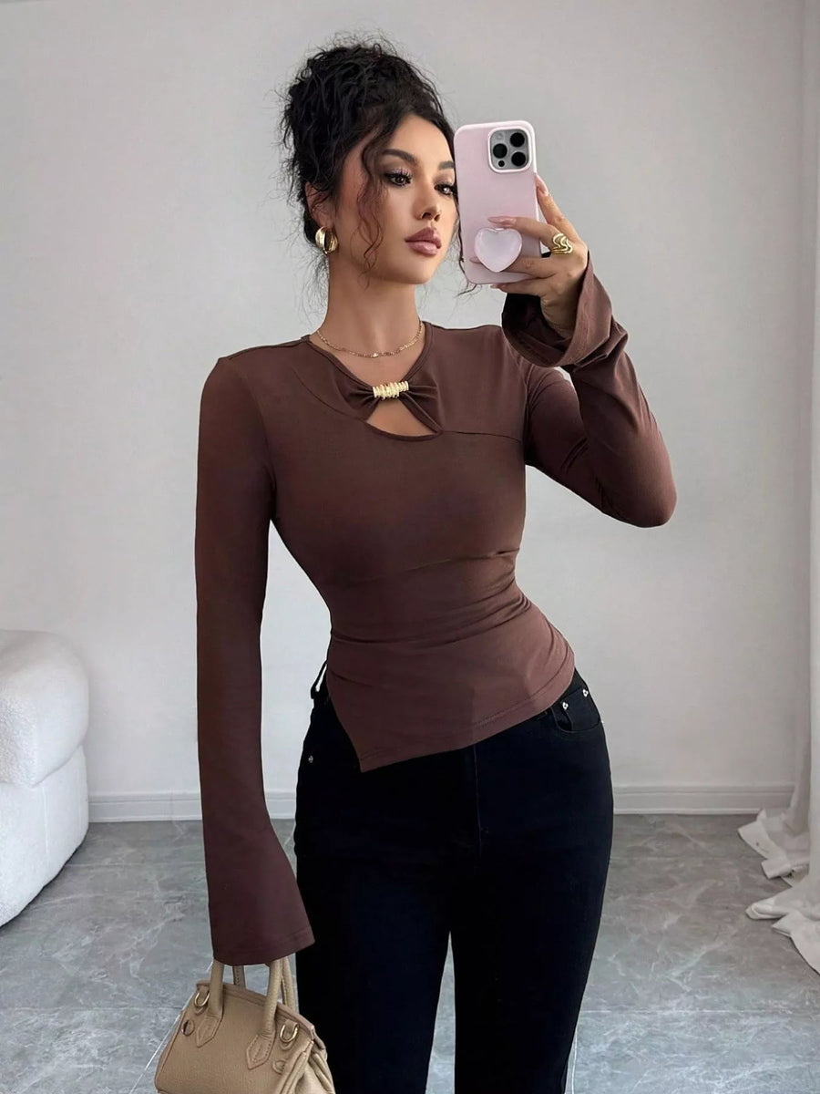 Brown asymmetrical cutout long-sleeve top with gold detail at neckline