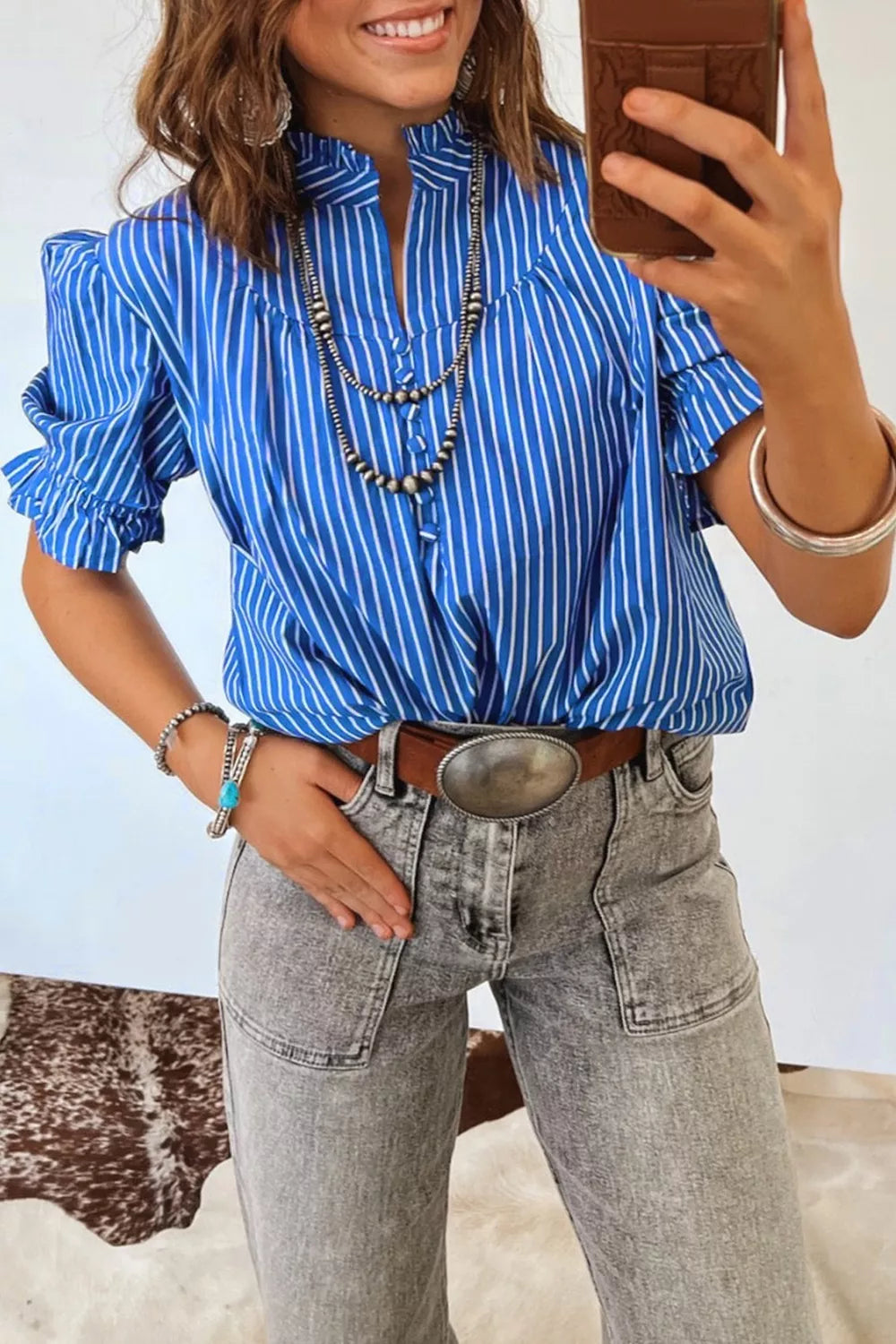 Blue striped cotton blend shirt with ruffled puff sleeves and button placket.