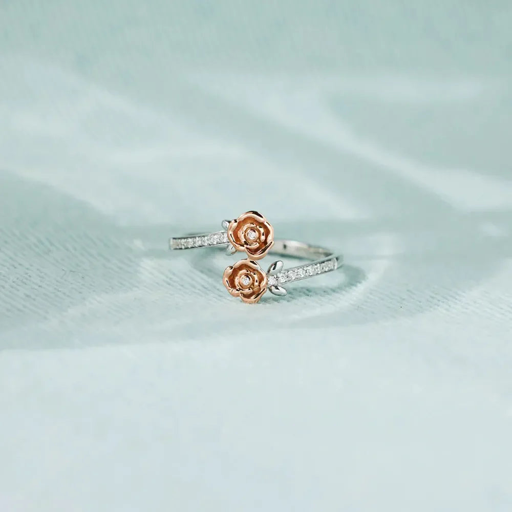 Rosebud bypass ring in silver with pavé detail and two rosebud charms.